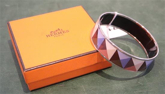 A Hermes, Paris enamelled bangle with geometric pattern, with pouch and box.